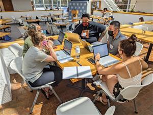 ETHS teacher Kamasi Hill (center) is working with a group of other teachers for a pilot project developed by the National Hum