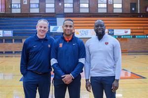 Chris Livatino, Miles Osei, and Dr. Marcus Campbell pose at center court at Beardsley Gym.